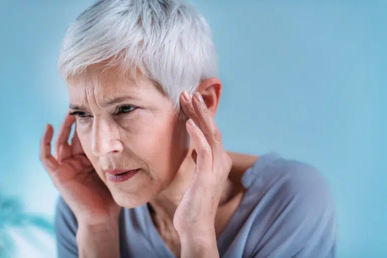 senior woman suffering from tinnitus